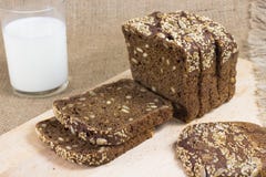 Black bread cut into slices. glass of milk Stock Images Black bread cut into slices. glass of milk Stock Images