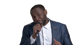 Black businessman in suit singing karaoke.