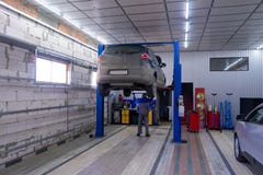 Black car in garage with special equipment prepared for repair stock image Black car in garage with special equipment prepared for repair stock image