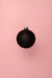 Black Christmas ball on the pink background stock images Black Christmas ball on the pink background stock images