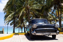 A black classic car parked near the beach. Black classic car parked near the beach Royalty Free Stock Image A black classic car parked near the beach. Black classic car parked near the beach Royalty Free Stock Image
