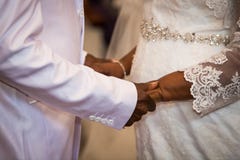 Black couple holding hands during marriage