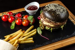 Black double hamburger made from beef with jalapeno pepper, cheese and vegetables-3 royalty free stock photography Black double hamburger made from beef with jalapeno pepper, cheese and vegetables-3 royalty free stock photography