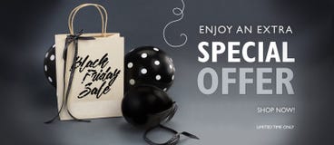 Black Friday sale banner containing recycled paper bag decorated with black satin ribbon, and black balloons.