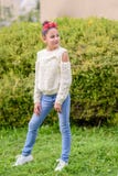 Black-headed girl wearing a floral crown standing in front of nature background a sunny day. stock photos Black-headed girl wearing a floral crown standing in front of nature background a sunny day. stock photos