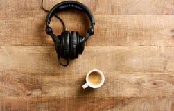Black headphones and a cup of coffee on rustic wooden background. royalty free stock photos Black headphones and a cup of coffee on rustic wooden background. royalty free stock photos