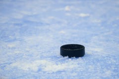 Black hockey puck on ice rink. Winter sport stock photo Black hockey puck on ice rink. Winter sport stock photo