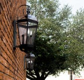 Black lanterns on brick wall in city street stock image Black lanterns on brick wall in city street stock image