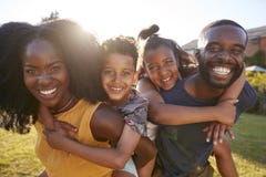 Black parents piggybacking their young kids, close up stock images Black parents piggybacking their young kids, close up stock images