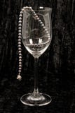 Black Pearls In Wine Glass. Stock Photo