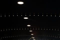 Black roof with white circular lights embedded and lines of smaller lights stock photo Black roof with white circular lights embedded and lines of smaller lights stock photo