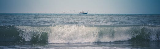 Black Ship on Green Sea Under White and Blue Sky at Daytime Stock Photography Black Ship on Green Sea Under White and Blue Sky at Daytime Stock Photography