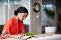 Black student making notes in her notebook sitting at home Stock Photography Black student making notes in her notebook sitting at home Stock Photography