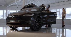 Black Tesla electric car model X in the promotion showroom.