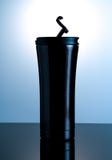 Black thermos bottle with open cap put on black glass with white royalty free stock image Black thermos bottle with open cap put on black glass with white royalty free stock image