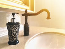 Black vintage water tap and bottle of liquid soap Royalty Free Stock Photo Black vintage water tap and bottle of liquid soap Royalty Free Stock Photo