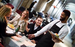 Black waiter serving table on the terrace royalty free stock photos Black waiter serving table on the terrace royalty free stock photos