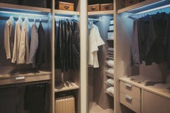 Black and white cloths hanging in wooden wardrobe at home stock photography Black and white cloths hanging in wooden wardrobe at home stock photography