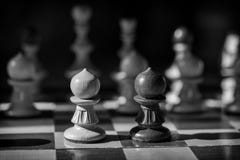 Black and white chess pawns face off Stock Photography Black and white chess pawns face off Stock Photography