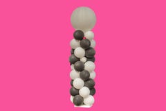 Black and white party balloons against pink background