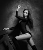 Beautiful and young girl posing in lingerie and Venetian mask on a violet armchair. Vintage interior and retro stock photography Beautiful and young girl posing in lingerie and Venetian mask on a violet armchair. Vintage interior and retro stock photography