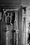 Black and white photo of old tools hung on a door royalty free stock photo Black and white photo of old tools hung on a door royalty free stock photo
