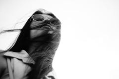 Black and white portrait young asian woman with sunglass and her hair is blow,and eye view,selective focus. royalty free stock photos Black and white portrait young asian woman with sunglass and her hair is blow,and eye view,selective focus. royalty free stock photos