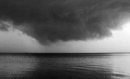 Black and white storm clouds and sea composition
