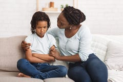 Black Woman Apologizing To Her Grumpy Child Stock Photography