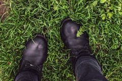 Black woman boots on green grass stock photo Black woman boots on green grass stock photo