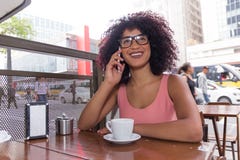 Black woman with frizzy hair using cell phone outdoors and havin Royalty Free Stock Image Black woman with frizzy hair using cell phone outdoors and havin Royalty Free Stock Image