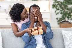 Black woman giving her boyfriend birthday gift
