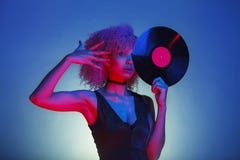 Black woman holding a retro vinyl with eighties disco music royalty free stock photography Black woman holding a retro vinyl with eighties disco music royalty free stock photography