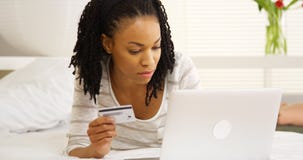 Black woman typing in credit card number stock image Black woman typing in credit card number stock image