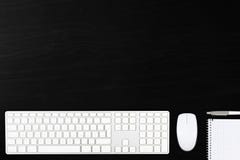 Black wooden office desk top view with computer mouse, keyboard, Royalty Free Stock Photo Black wooden office desk top view with computer mouse, keyboard, Royalty Free Stock Photo
