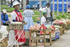 Black Zulu women in brightly colored clothing sell vegetables and produce as street vendors in Zulu village, Zululand, South stock photos Black Zulu women in brightly colored clothing sell vegetables and produce as street vendors in Zulu village, Zululand, South stock photos