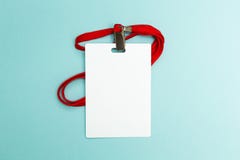 Blank badge mockup isolated on blue background. Plain empty name tag mock up with red string stock photos Blank badge mockup isolated on blue background. Plain empty name tag mock up with red string stock photos