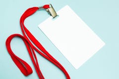 Blank badge mockup isolated on blue. Plain empty name tag with red string stock images Blank badge mockup isolated on blue. Plain empty name tag with red string stock images
