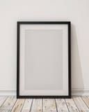 Blank black picture frame on the wall and the floor