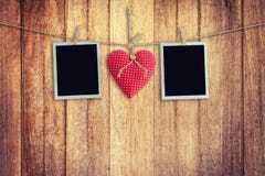 Blank instant photos and red heart hanging on wooden background. royalty free stock photo Blank instant photos and red heart hanging on wooden background. royalty free stock photo