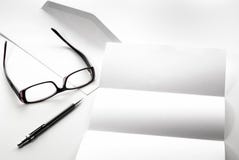 blank of letter paper and envelope with eyeglasses and pen Stock Photography blank of letter paper and envelope with eyeglasses and pen Stock Photography