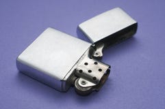 Blank metal lighter open on a purple table stock image Blank metal lighter open on a purple table stock image