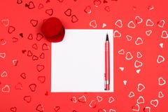 Blank page with pen on red background with heart-shaped confetti stock photos Blank page with pen on red background with heart-shaped confetti stock photos