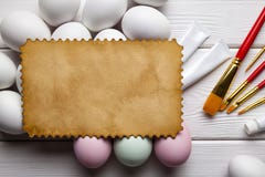 Blank paper sheet, colored and white eggs, brushes and paints on white table Royalty Free Stock Photo Blank paper sheet, colored and white eggs, brushes and paints on white table Royalty Free Stock Photo