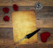 Blank vintage card with red cuddle hart, red roses, ink and quill on vintage oak, love letter on antique oak - top view stock image Blank vintage card with red cuddle hart, red roses, ink and quill on vintage oak, love letter on antique oak - top view stock image