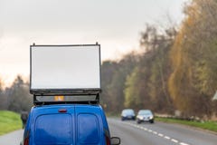 Blank white advertising banner sign on car roof next to UK motorway royalty free stock photos Blank white advertising banner sign on car roof next to UK motorway royalty free stock photos