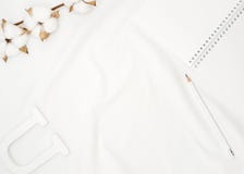 Blank white spiral notebook with pencil, cotton flowers and wooden letter on white bed sheet. royalty free stock images Blank white spiral notebook with pencil, cotton flowers and wooden letter on white bed sheet. royalty free stock images
