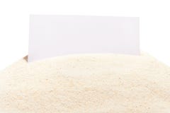 Blank white visit card on pile of beach sand. On white background Stock Photos Blank white visit card on pile of beach sand. On white background Stock Photos