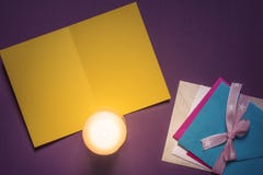 Blank yellow message card and candlelight stock photo Blank yellow message card and candlelight stock photo
