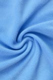 The blanket of furry blue fleece fabric. A background of light blue soft plush fleece material with a lot of relief folds. stock photo The blanket of furry blue fleece fabric. A background of light blue soft plush fleece material with a lot of relief folds. stock photo